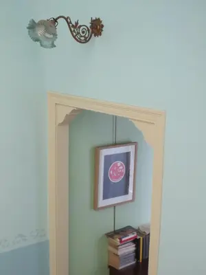 a mirror in a room with a picture on the wall at 1900 B&B Terrassa in Terrassa