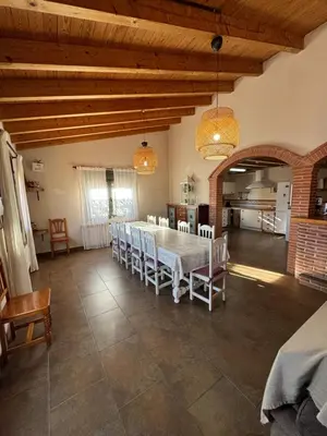 a large dining room with a table and chairs at Molí den burch in Santa Eulalia de Ronsaná