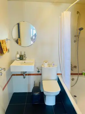 a bathroom with a toilet and a sink and a mirror at Forum de Barcelona Sea View Apartment with Garage Parking in Sant Adria de Besos