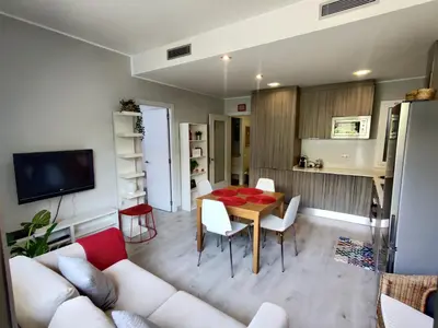 a living room with a white couch and a table at Fira Plaza España apartment in Barcelona