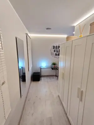 a hallway with white cabinets and a table in a room at Fira Plaza España apartment in Barcelona