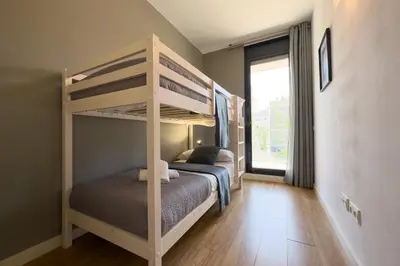 a bedroom with two bunk beds and a window at ChicStays Apartment Vila Olímpica in Barcelona