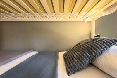 a bed with a black blanket on top of it at ChicStays Apartment Vila Olímpica in Barcelona