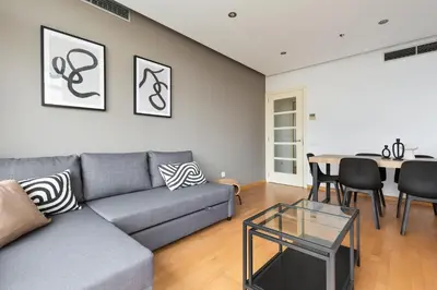 a living room with a couch and a table at ChicStays Apartment Vila Olímpica in Barcelona