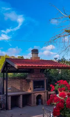 a large brick dog house with a red roof at Casa Can Roura in Vilassar de Dalt