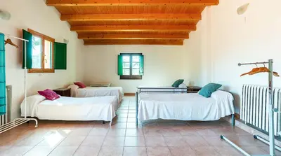 a hospital room with two beds and a wooden ceiling at Casa Can Roura in Vilassar de Dalt