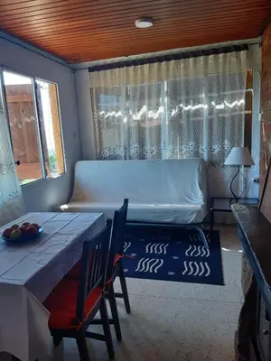 a bedroom with a bed and a table and chairs at Apartamentos Can bruguera 3 in Mataró