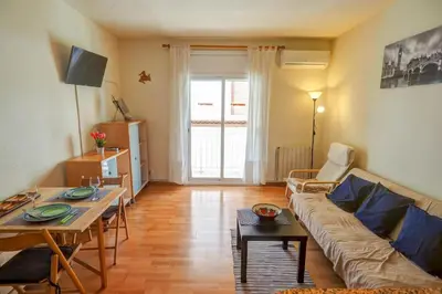 a living room with a couch and a table at Hermione Apartment by Hello Homes Sitges in Sitges
