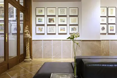 a waiting room with a couch and pictures on the wall at Hotel Astoria in Barcelona