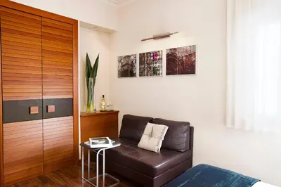 a living room with a brown leather couch and a table at Hotel Astoria in Barcelona