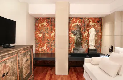 a living room with a large painting on the wall at Claris Hotel & Spa GL, a Small Luxury Hotel of the World in Barcelona