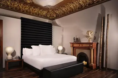 a bedroom with a white bed and a wooden closet at Hotel Balmes, a member of Preferred Hotels & Resorts in Barcelona