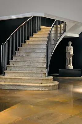 a staircase in a building with a statue at Hotel Derby in Barcelona