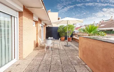 a patio with an umbrella and a table and chairs at Hotel Derby in Barcelona