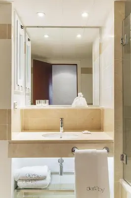 a bathroom with a sink and a mirror at Hotel Derby in Barcelona