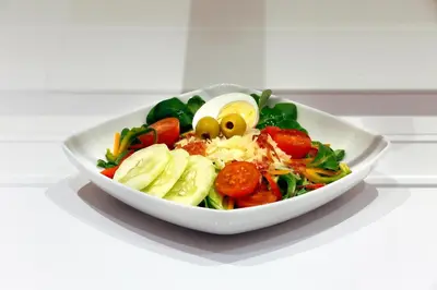 a salad in a white bowl on a table at HCC Taber in Barcelona