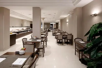 a row of tables and chairs in a restaurant at HCC Taber in Barcelona
