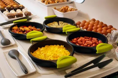 a buffet with bowls of food on a table at HCC Taber in Barcelona
