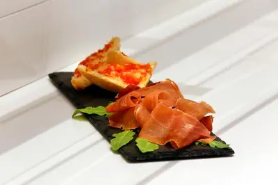 a plate of food with salmon and a piece of bread at HCC Taber in Barcelona