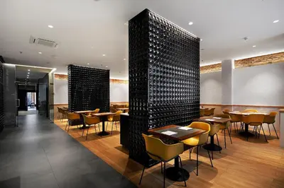 a restaurant with tables and chairs in a room at HCC Regente in Barcelona