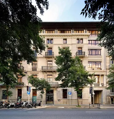 a large building with motorcycles parked in front of it at HCC St. Moritz in Barcelona