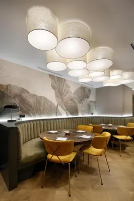 a dining room with a couch and a table and chairs at HCC St. Moritz in Barcelona