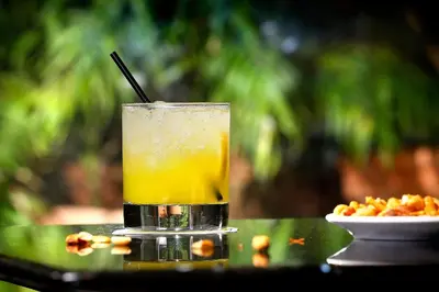 a drink sitting on a table next to a plate of food at HCC St. Moritz in Barcelona