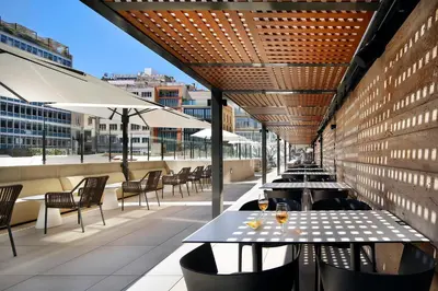 a row of tables and chairs on a patio at HCC St. Moritz in Barcelona