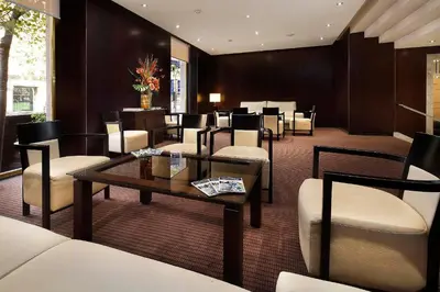 a lobby with a waiting room with chairs and a table at HCC St. Moritz in Barcelona