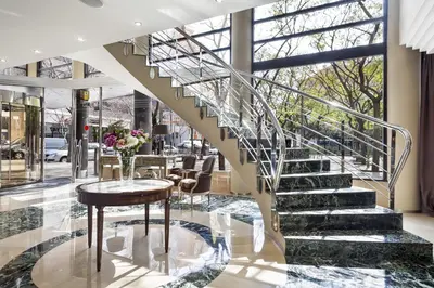 a staircase in a lobby with a table and chairs at Acta CITY47 in Barcelona