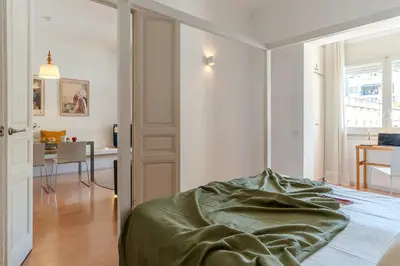 a bedroom with a bed and a dining room at Canela Homes BARCELONA CASP in Barcelona