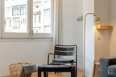 a black chair in a room with a window at Canela Homes BARCELONA CASP in Barcelona