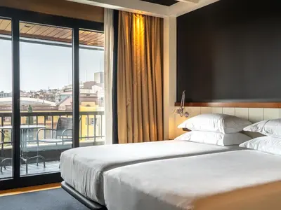 a bedroom with a large bed and a balcony at U232 Hotel in Barcelona