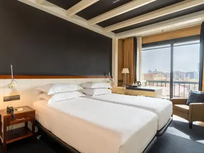 a large white bed in a room with a large window at U232 Hotel in Barcelona