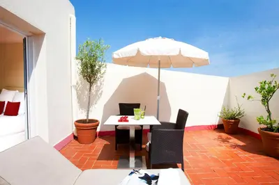 a patio with a table and an umbrella at Grupotel Gravina in Barcelona
