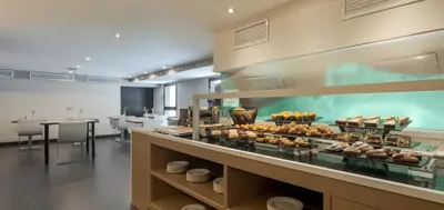 a restaurant with a display case with food in it at Ilunion Almirante in Barcelona