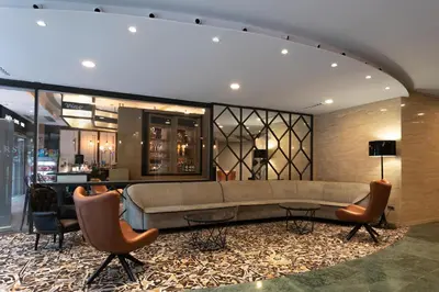 a lobby with a couch and chairs and a table at Eurostars Cristal Palace in Barcelona