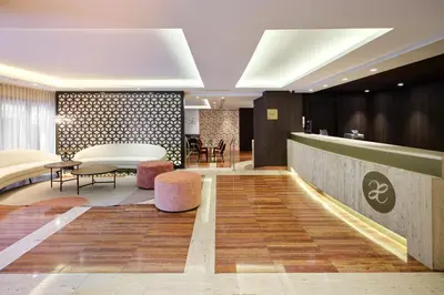 a lobby of a hotel with a table and chairs at Exe Mitre in Barcelona