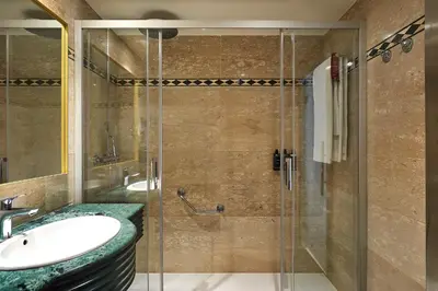 a bathroom with a sink and a glass shower at Exe Mitre in Barcelona