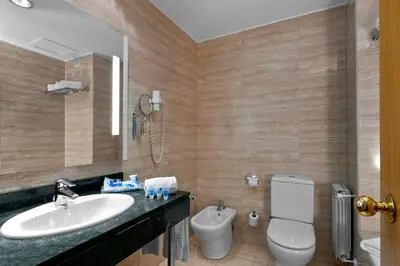 a bathroom with a sink and a toilet at Exe Parc del Vallés in Cerdanyola del Valles