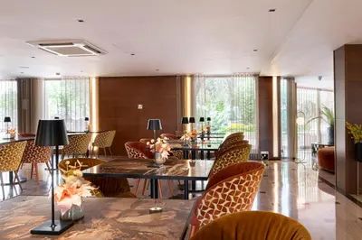 a dining room with tables and chairs and windows at Exe Parc del Vallés in Cerdanyola del Valles