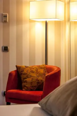 a red chair with a pillow in a room at Zenit Barcelona in Barcelona