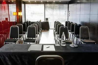 a conference room with a table with chairs and a laptop at Zenit Barcelona in Barcelona