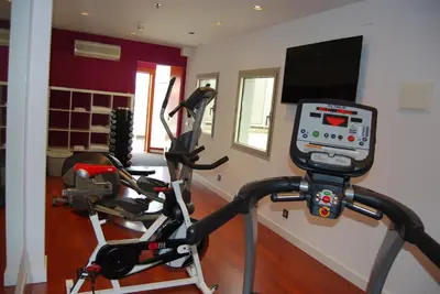 a gym with two exercise bikes and a television at Zenit Barcelona in Barcelona