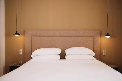 a large bed with two pillows on top of it at H La Paloma Boutique in Barcelona