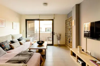 a living room with a couch and a table at Apt.p/5 15min from Barcelona and Beaches W/Terrace in Sant Adria de Besos