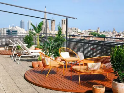 a group of chairs and tables on a roof at Citadines Ramblas Barcelona in Barcelona
