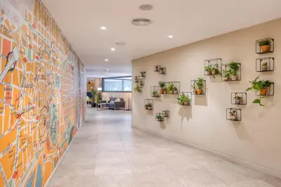 a hallway with plants on the wall at Citadines Ramblas Barcelona in Barcelona