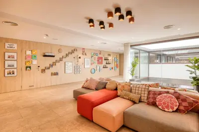 a living room with a red couch in a room at Citadines Ramblas Barcelona in Barcelona