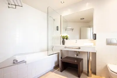 a bathroom with a sink and a tub and a mirror at Arc La Rambla in Barcelona